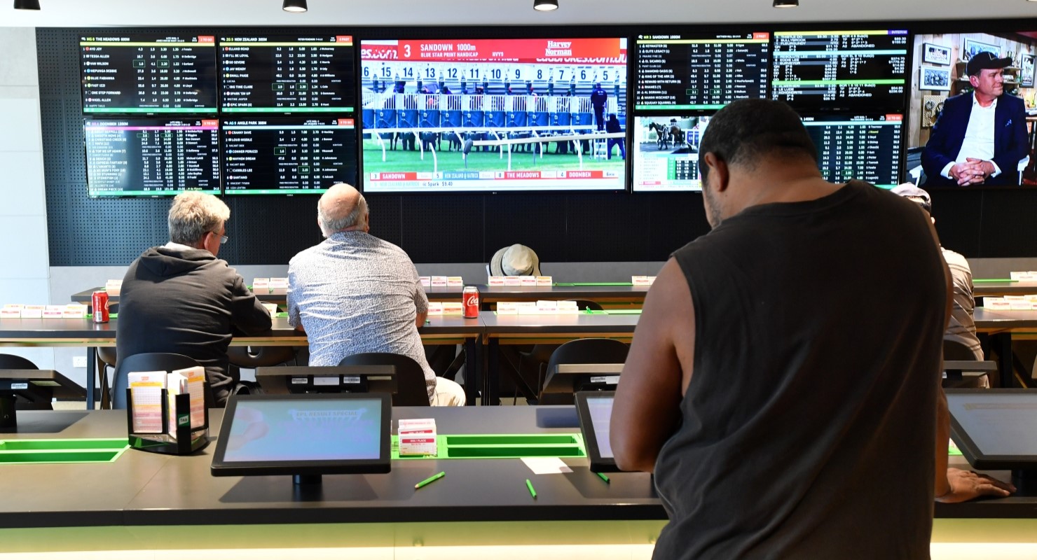 Customers inside a Tabcorp venue (Image: AAP/Darren England)