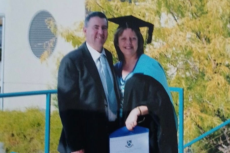 woman holding her graduation certificate